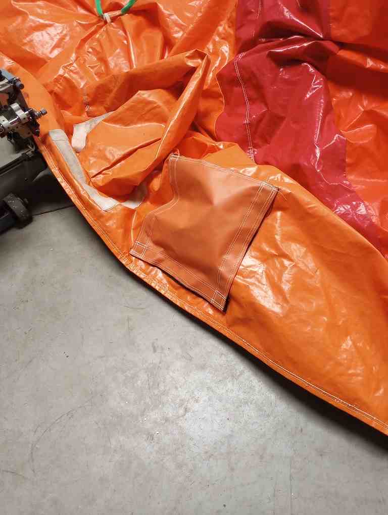 Replacement vinyl panel being sewn in on a commercial machine